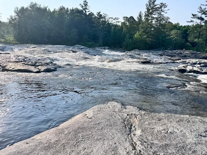 Flowing AuSable water over broad rock shelves in the Jay upstream swimming-area collection