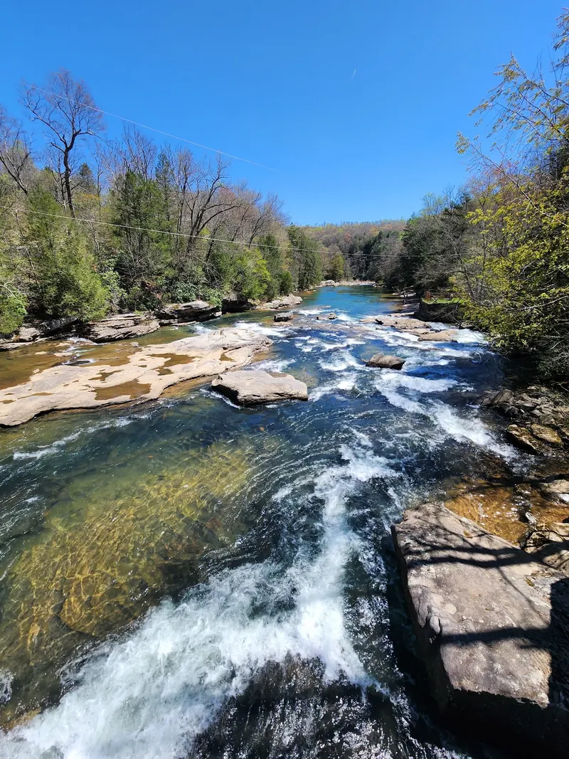 Whitewater flowing between exposed rock ledges in Audra State Park