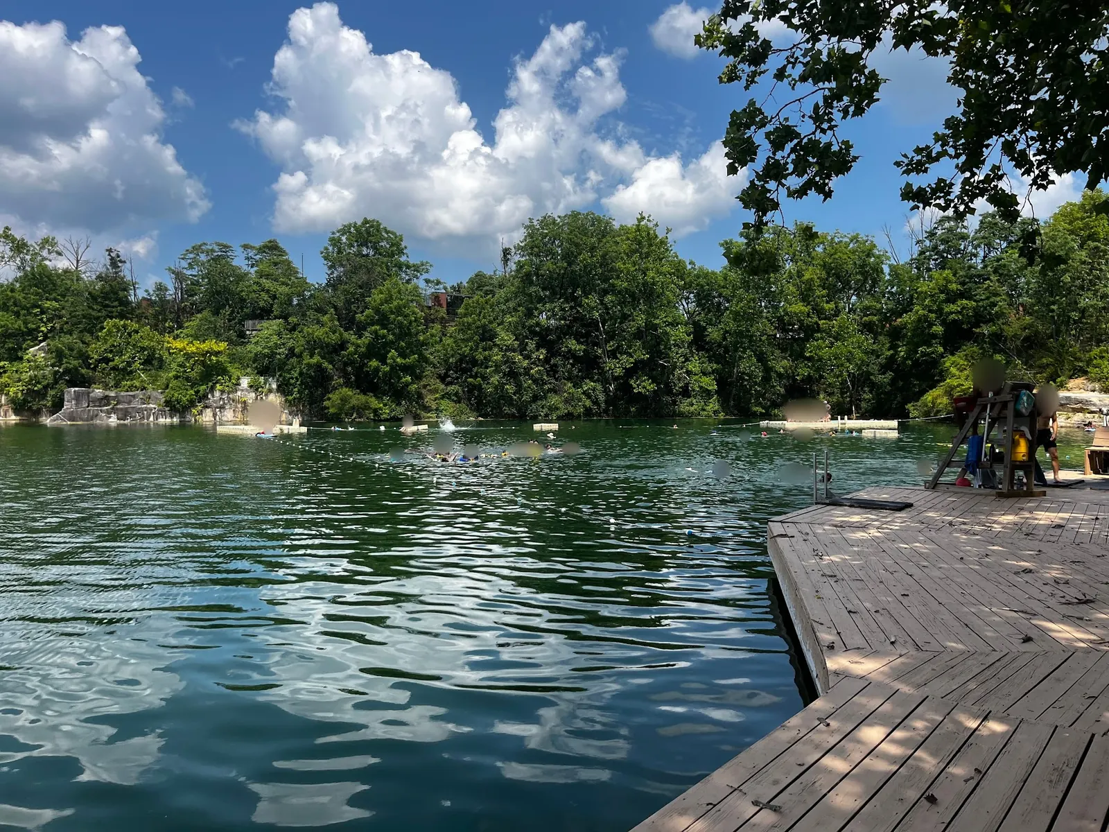 Wooden deck beside the tree-lined quarry at Beaver Dam Swimming Club