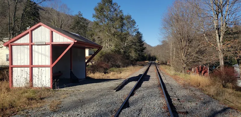 Railway shelter marked Bemis beside tracks, shown as historical area context rather than a walking route or confirmation of a current passenger stop