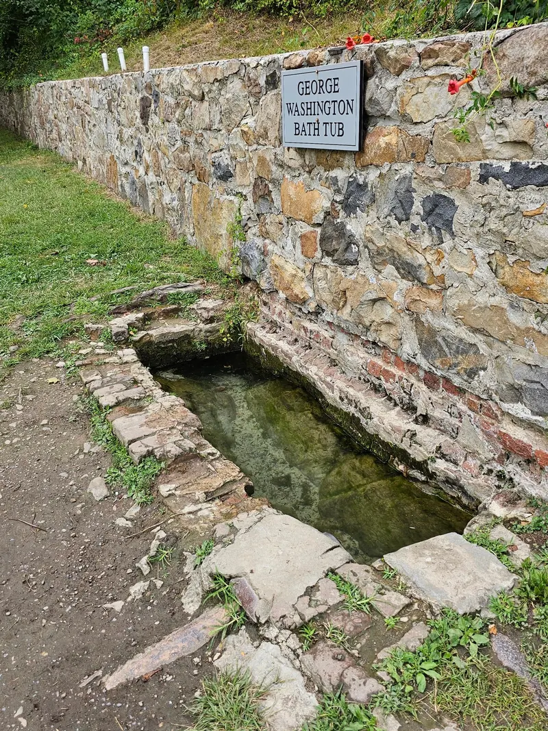 Historic stone basin labeled George Washington Bathtub at Berkeley Springs State Park