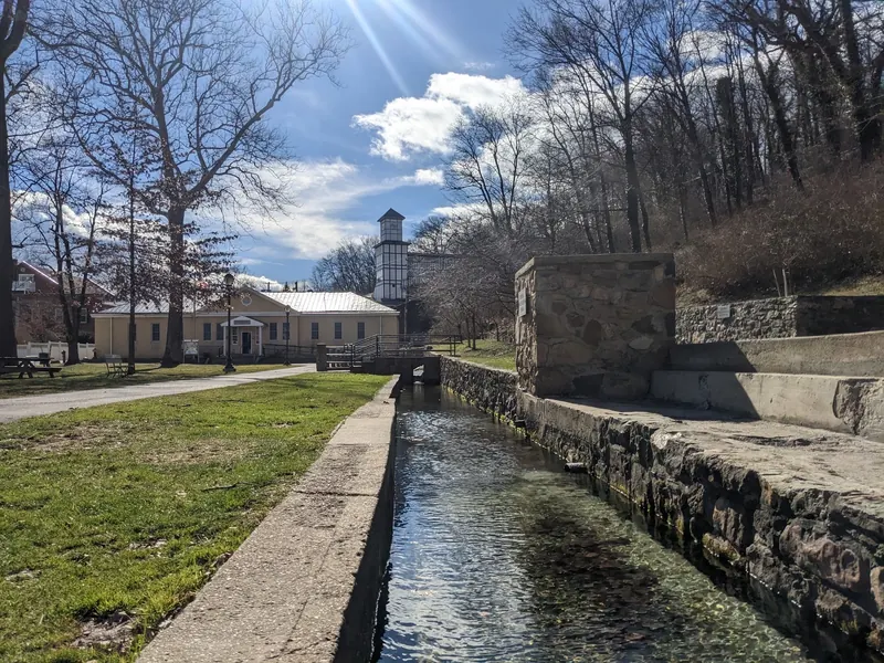 Spring channel beside stone walls and park lawns at Berkeley Springs State Park