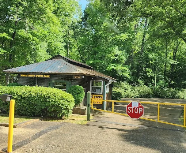 Bogue Chitto Water Park office beside a yellow entrance barrier and stop sign