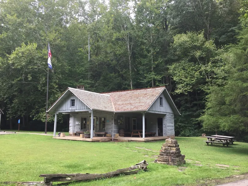 Wooden park building and picnic tables at Cedar Creek State Park, shown for general park context
