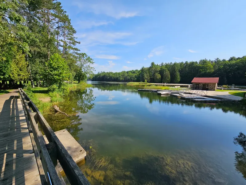 Boathouse and docks beside a lakeside walkway at Chenango Valley State Park