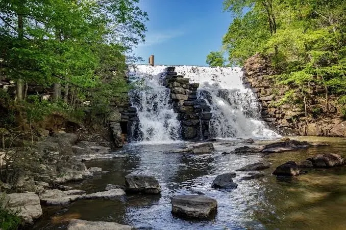 Water spilling over the stone dam at Chewacla State Park