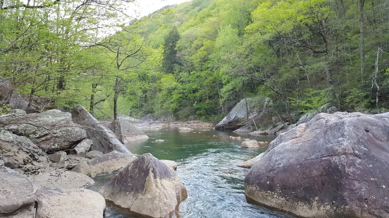 Historical North Chickamauga Creek view with water flowing between large boulders; present access is closed