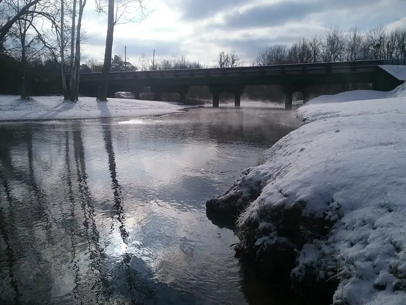 Snow-covered banks beside the Coldwater Creek highway bridge in a historical winter photo