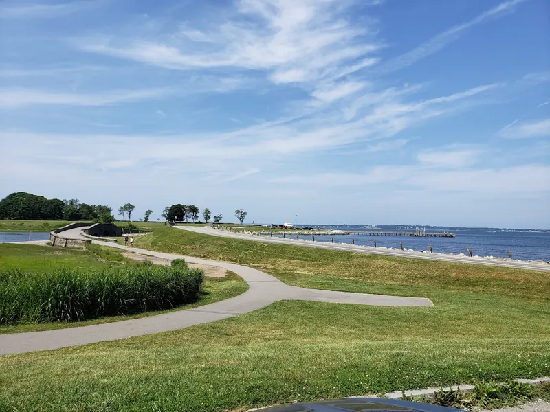 Paved paths, stone bridge and distant fishing pier at Colt State Park, not Bristol Town Beach