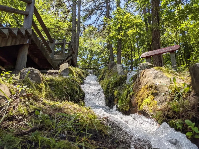 Small cascade beside wooden steps and a Restricted Area Do Not Enter sign in the Crowley's Ridge park collection; not a swimming entrance