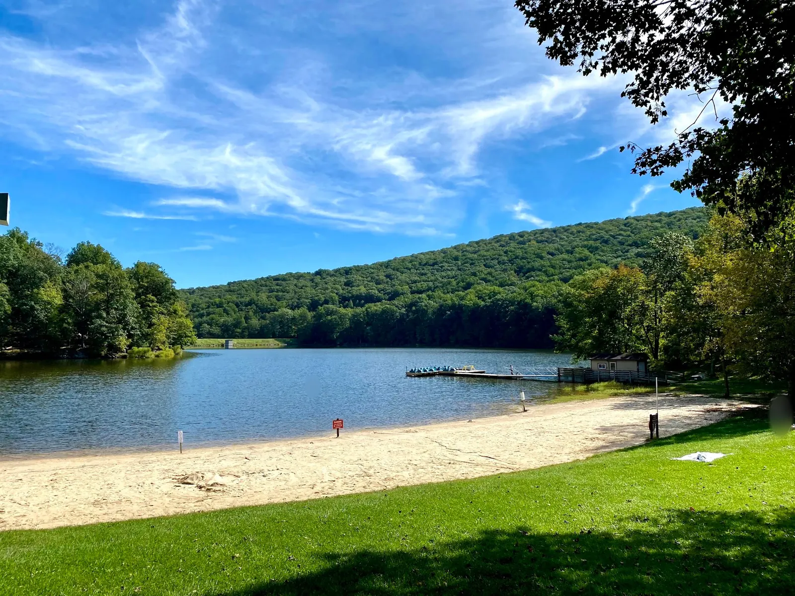 Sandy shore and wooded hills around Hunting Creek Lake at Cunningham Falls State Park