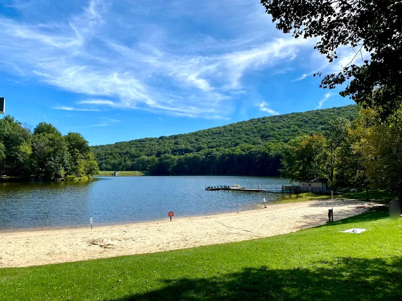 Sandy shore and wooded hills around Hunting Creek Lake at Cunningham Falls State Park