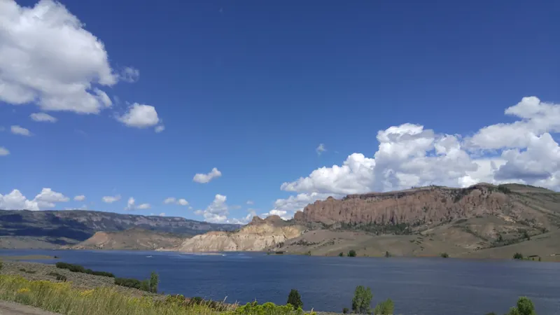 Broad reservoir water and mesa cliffs in the Curecanti photo collection; landscape context, not a marked swimming entrance