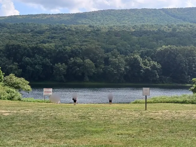 Grassy approach to the Delaware River at Smithfield Beach, Pennsylvania, with wooded hills across the river
