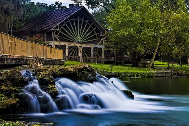 Wooden mill wheel beside the spring outflow at De Leon Springs State Park, outside the designated swimming pool