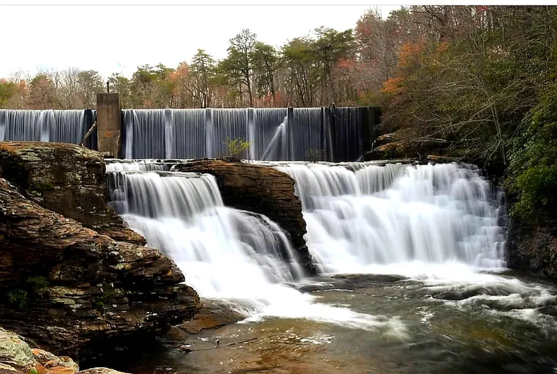 Water spilling over a concrete dam and stepped rock ledges in the DeSoto park collection