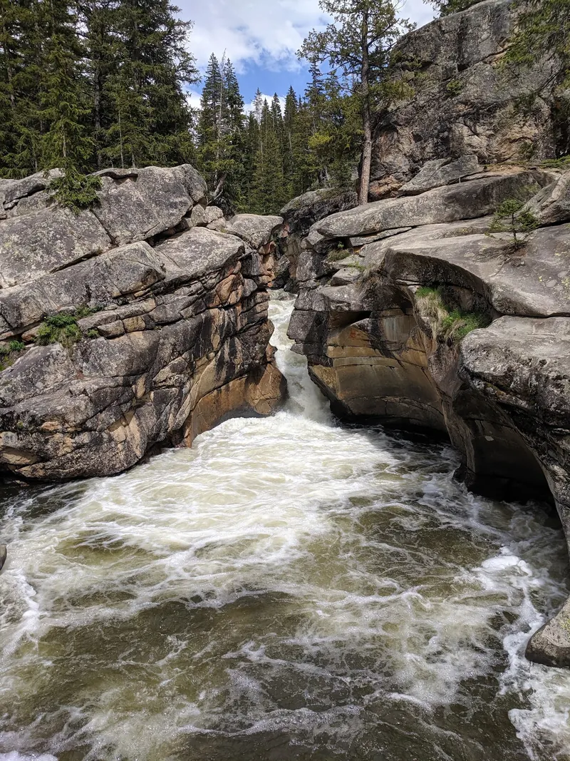 Cascading water between rounded rock shelves in the Aspen Devil's Punchbowl photo collection