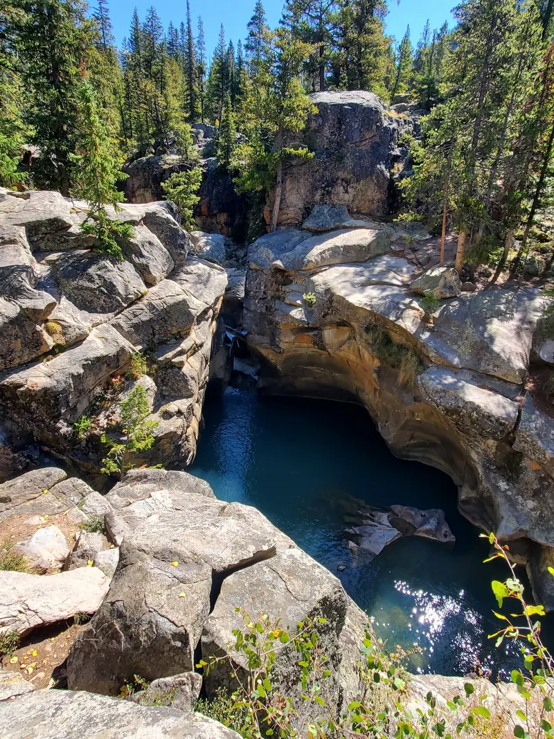 Rounded rock walls and blue water in the Aspen Devil's Punchbowl gorge photo collection