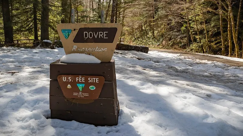 Dovre Recreation sign and fee station surrounded by snow, photographed during a past winter visit