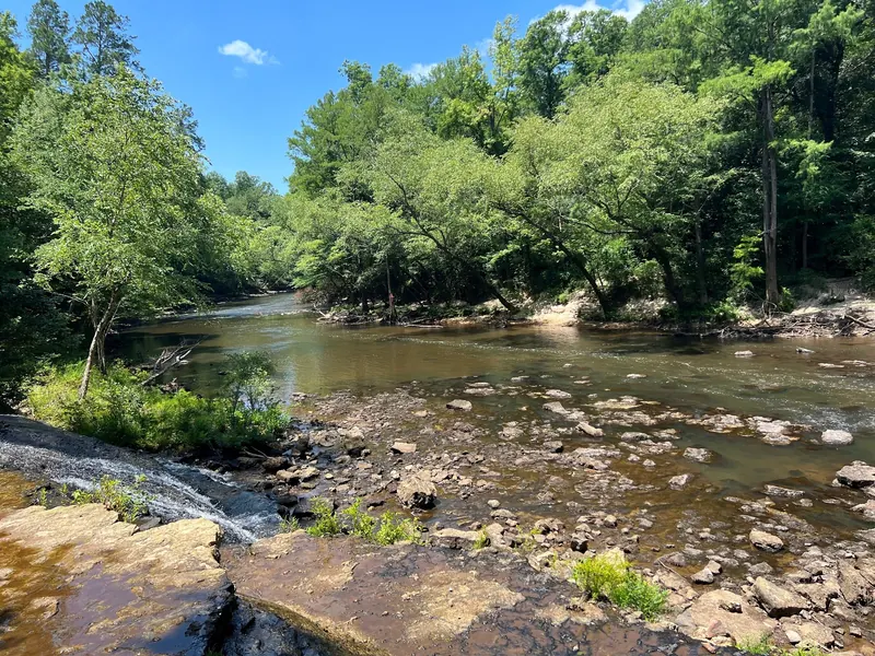 Chunky River and rocky wooded banks near Dunn's Falls, not a confirmed marked swimming area