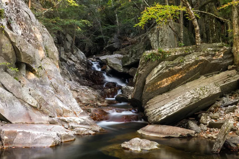Small cascades flowing between boulders at Falls of Lana