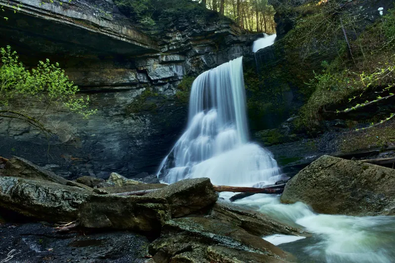 Waterfall dropping between layered gorge walls in the Fillmore Glen State Park collection; historical scenery, not the designated swimming area
