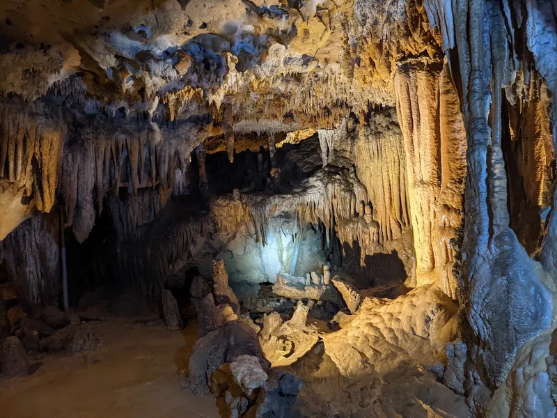 Illuminated limestone formations inside Florida Caverns State Park's dry caverns, a separate attraction from Blue Hole swimming