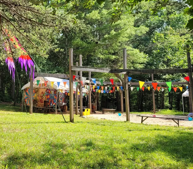 Wooden gathering structure decorated with colorful pennants in the Four Quarters grounds photo collection