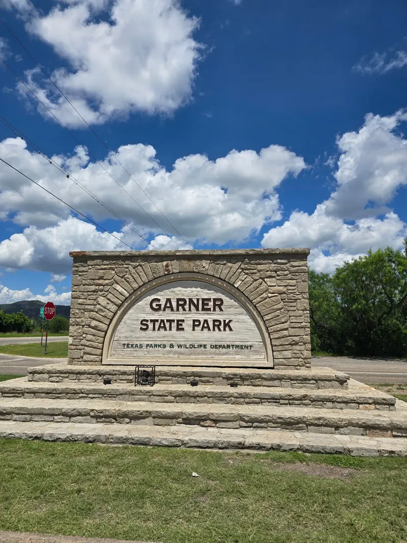 Stone Garner State Park entrance sign beside a paved road