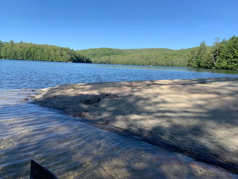 Rocky Glen Lake shoreline with water and wooded hills beyond