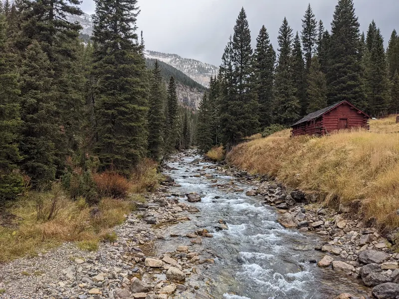 Granite Creek and a red wooden cabin near Granite Hot Springs; surrounding scenery, not the soaking pool