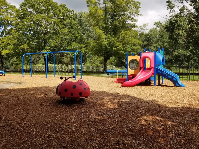 Empty playground with swings and colorful slides at Green River Swimming and Recreation Area