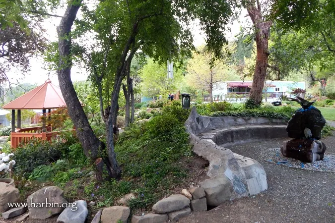 Operator-watermarked historical garden seating area, small pavilion and decorative fountain at Harbin Hot Springs; not a swimming pool or verified accessible route