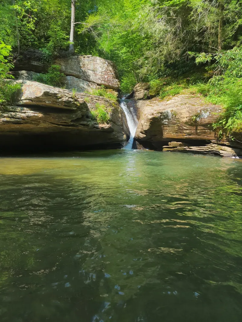 Narrow cascade between rock walls in Holly River State Park; the exact waterfall identity has not been independently confirmed