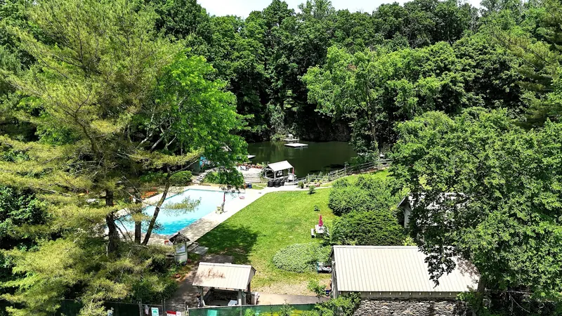 Hopewell Quarry grounds with the separate swimming pool, lawn and wooded quarry basin
