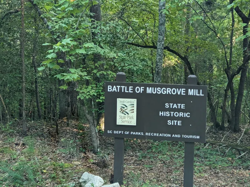 Battle of Musgrove Mill State Historic Site sign in a wooded setting
