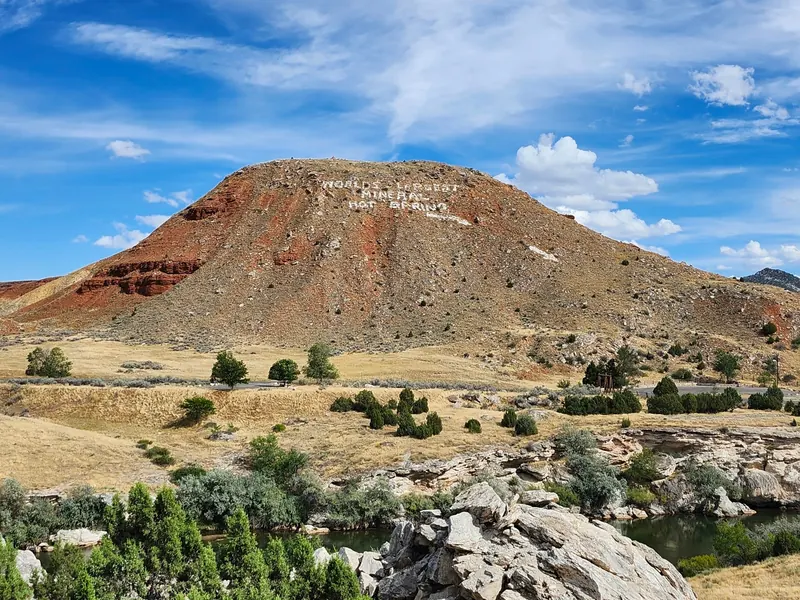 Hillside lettering above the river at Hot Springs State Park in Thermopolis
