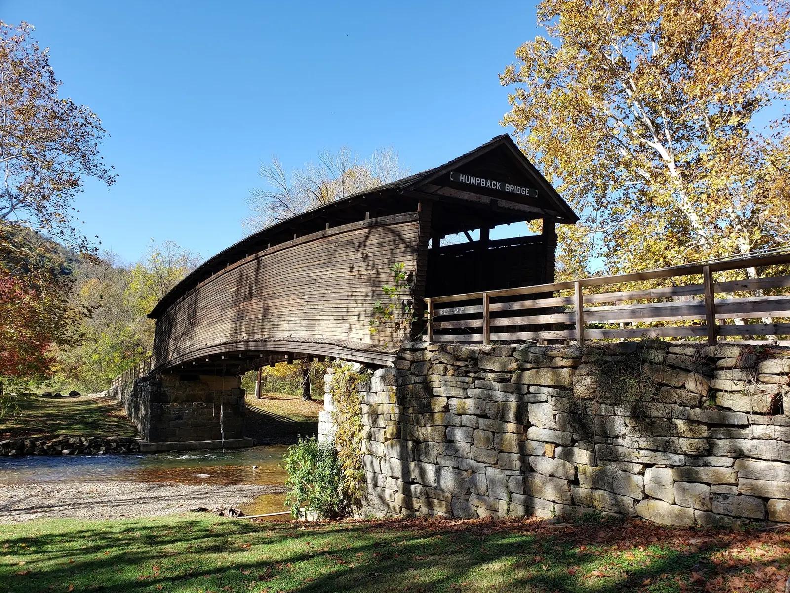 Timber Humpback Bridge above Dunlap Creek with autumn trees