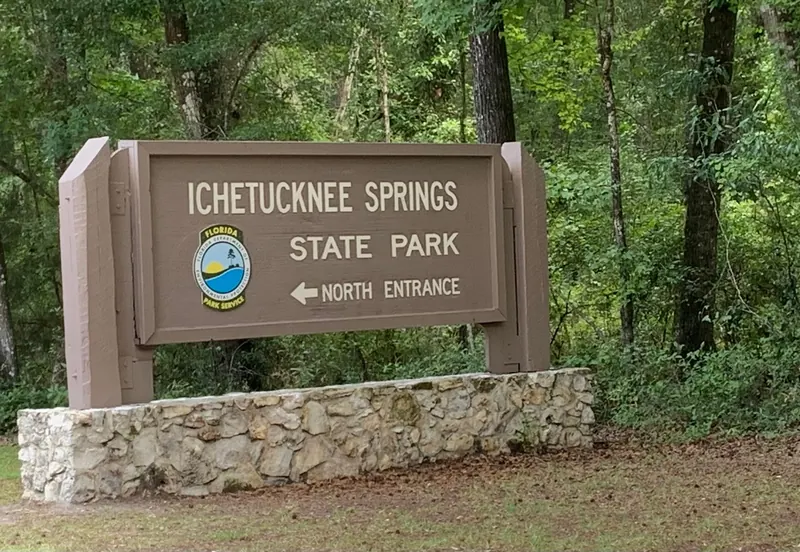 Ichetucknee Springs State Park sign pointing toward the North Entrance; historical arrival context