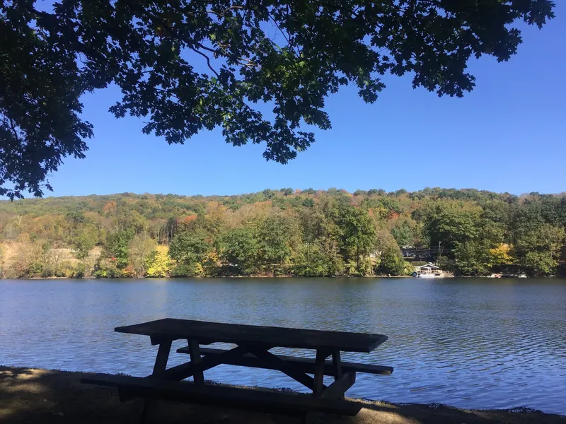 A shaded picnic table overlooking the Housatonic River at Indian Well State Park