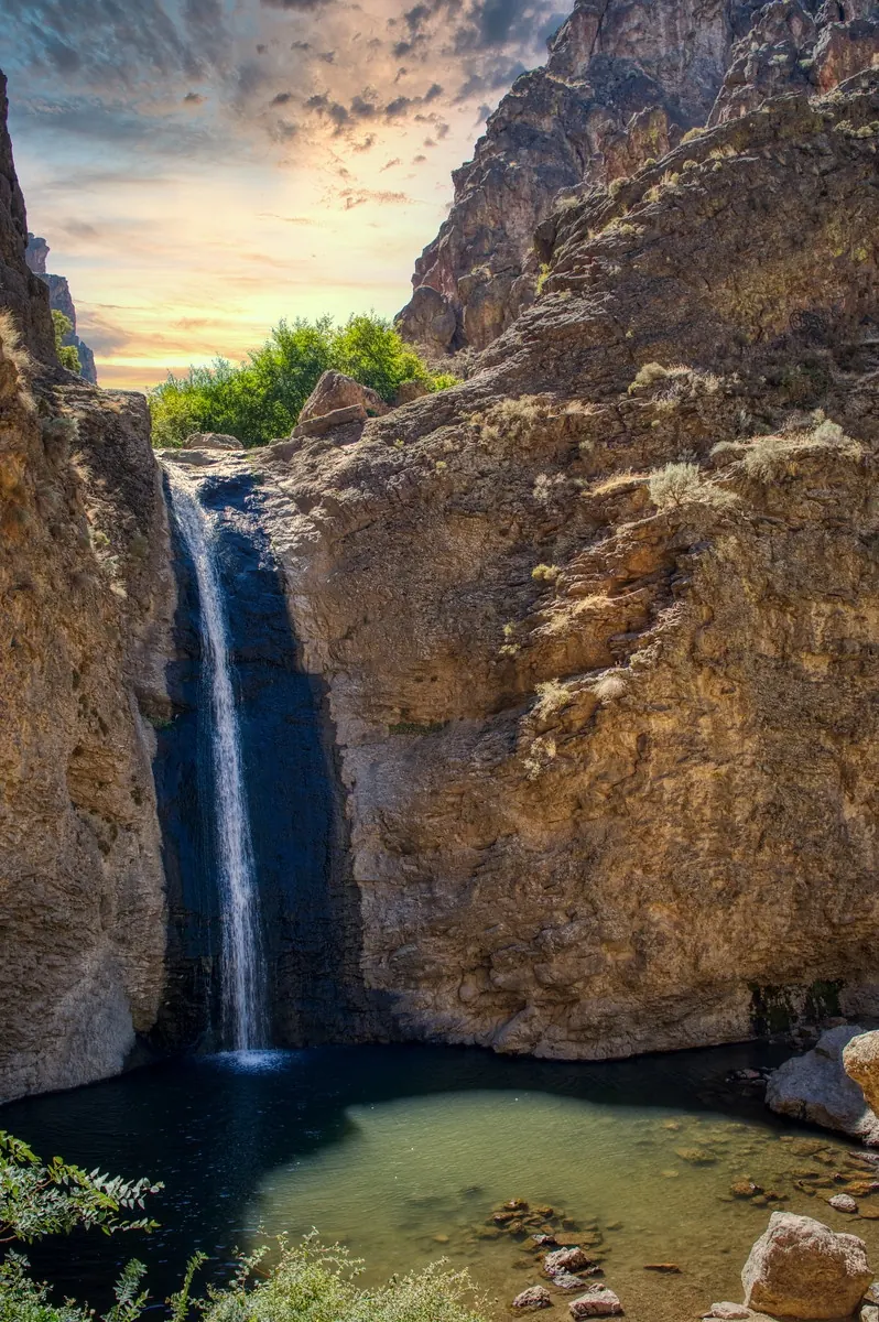 Historical Jump Creek Falls dropping between canyon walls into its pool; water depth and conditions are not established by the photo