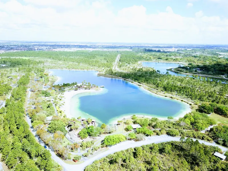Historical aerial view of the Larry and Penny Thompson lake and sandy beach; not current swimming conditions