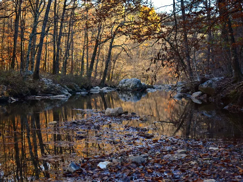Autumn trees reflected in a rocky creek reach in the Little Missouri Falls photo collection; regional scenery with no exact pool or water-entry identification