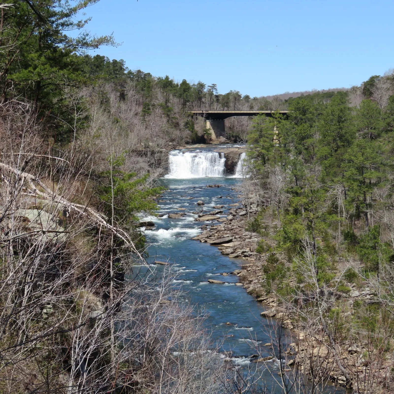 Main Little River Falls beneath the Highway 35 bridge with rocky river scenery downstream; not Little Falls