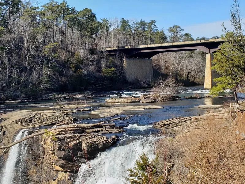 Water passing over the main Little River Falls rock ledge beneath the highway bridge