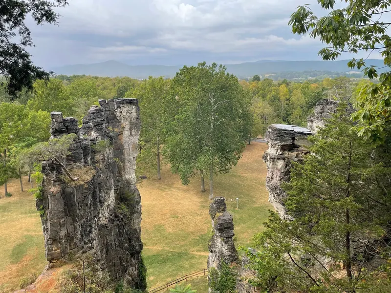Elevated view of Natural Chimneys rock towers, park lawns and distant wooded hills