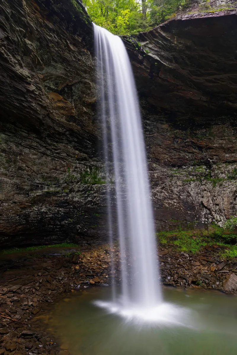 Ozone Falls dropping into a rock-lined pool beneath the sandstone amphitheater