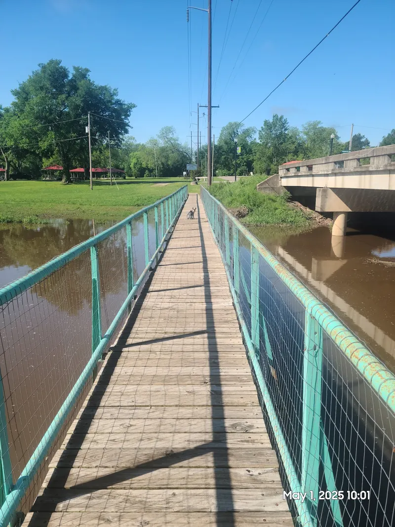 Pedestrian bridge with turquoise railings over Pennington Creek, with its original photo date stamp