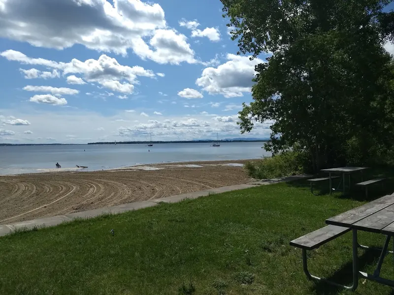 Sandy Lake Champlain shoreline and picnic tables at Point Au Roche State Park