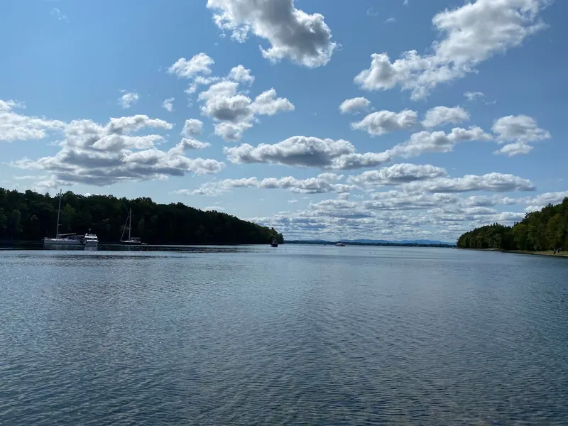 Boats on a wooded bay in a historical Point Au Roche State Park view